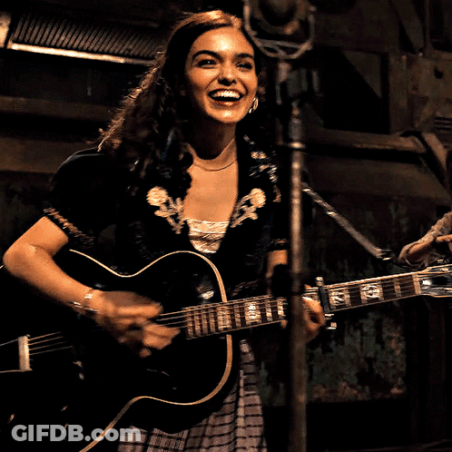 Woman Singing Into Microphone Holding G Guitar GIF