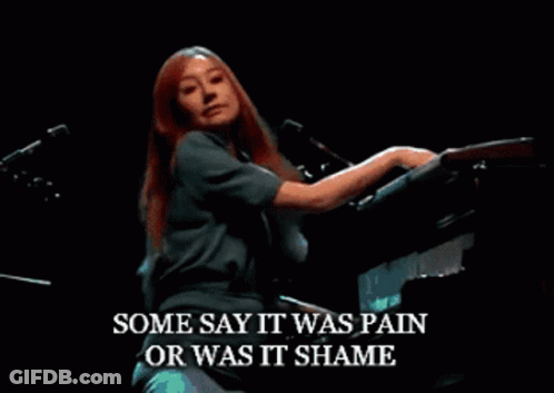 Woman Singing Into Microphone While Playing Piano GIF