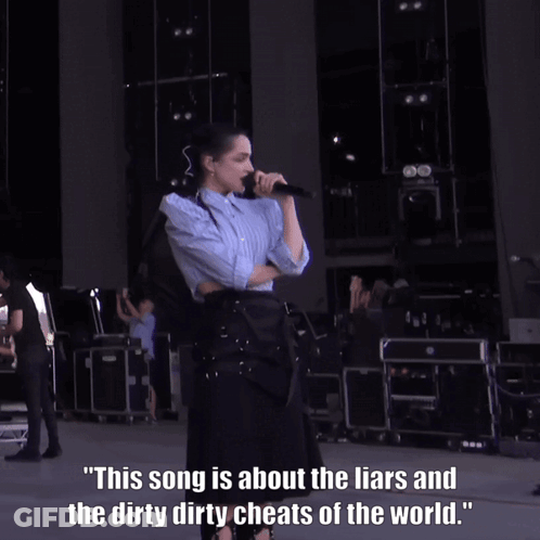 A Woman Singing Into A Microphone With A Caption That Says This Song Is About The Liars GIF
