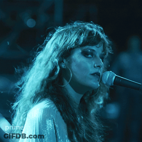 A Woman Singing Into A Microphone With A Prime Logo In The Corner GIF
