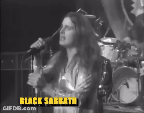 A Woman Singing Into A Microphone With Black Sabbath Written On The Bottom Right GIF