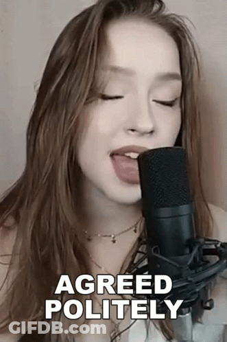 A Woman Singing Into A Microphone With Her Tongue Out And The Words Agreed Politely Above Her GIF