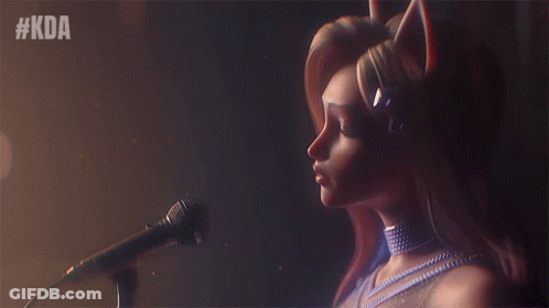 A Woman Singing Into A Microphone With The Hashtag #Kda Behind Her GIF