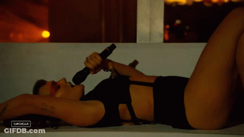 A Woman Singing Into A Microphone With The Word Cachella On The Bottom Left GIF