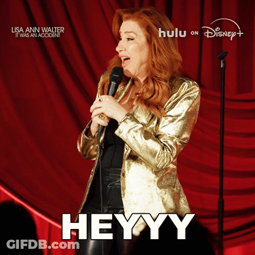 A Woman Singing Into A Microphone With The Word Heyy On The Bottom GIF