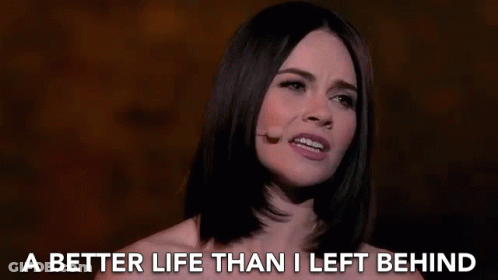 A Woman Singing Into A Microphone With The Words " A Better Life Than I Left Behind " Behind Her GIF