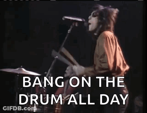 A Woman Singing Into A Microphone With The Words Bang On The Drum All Day Written Below Her GIF