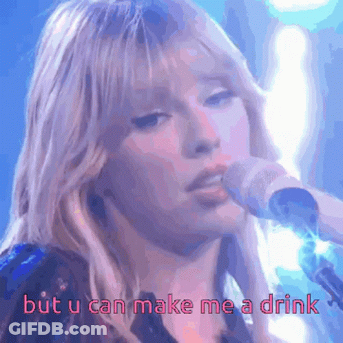 A Woman Singing Into A Microphone With The Words " But U Can Make Me A Drink " Below Her GIF