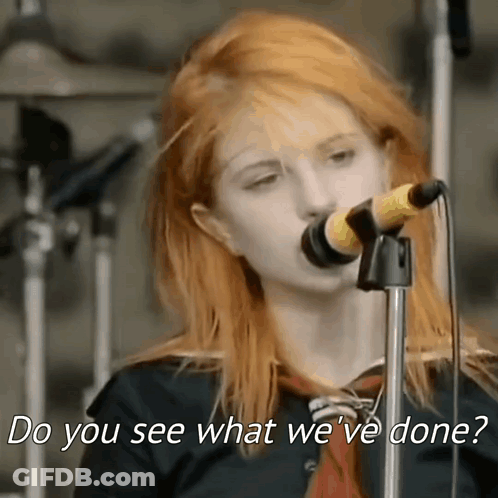 A Woman Singing Into A Microphone With The Words `` Do You See What We 'Ve Done '' Written Below Her . GIF