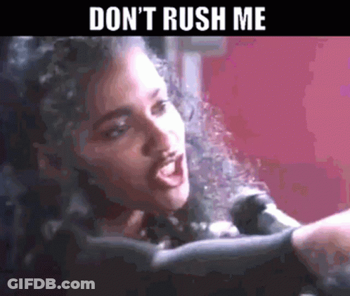 A Woman Singing Into A Microphone With The Words " Don 'T Rush Me " Above Her GIF