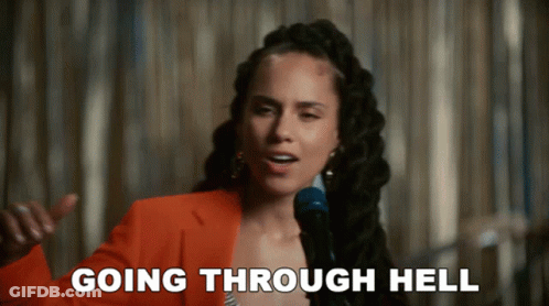 A Woman Singing Into A Microphone With The Words Going Through Hell Written Below Her GIF