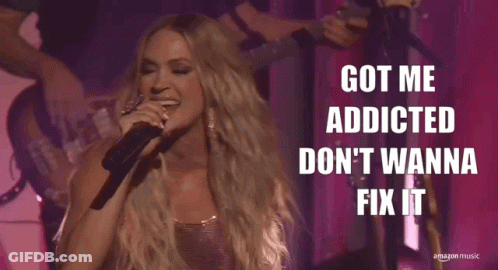A Woman Singing Into A Microphone With The Words Got Me Addicted Don 'T Wanna Fix It Above Her GIF