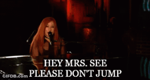 Woman Singing Into Microphone With Hey Mrs Please Don't Jump Text GIF