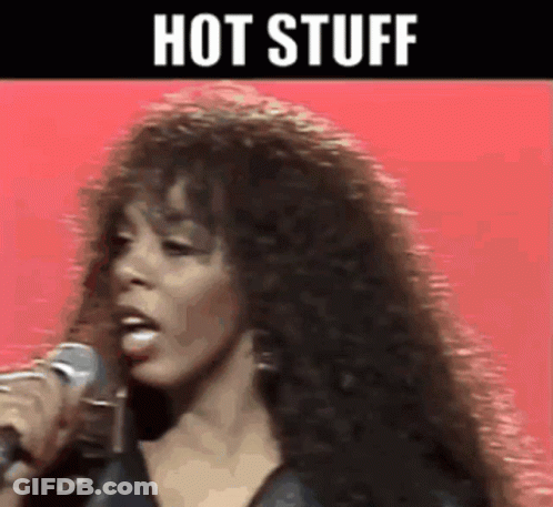 A Woman Singing Into A Microphone With The Words Hot Stuff Written Above Her GIF