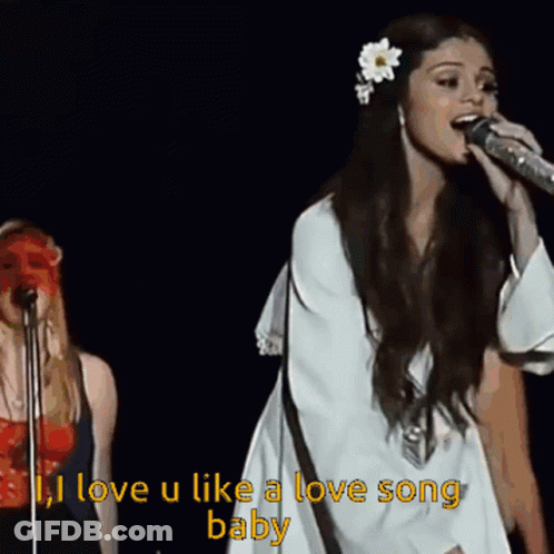 A Woman Singing Into A Microphone With The Words " I Love U Like A Love Song Baby " GIF
