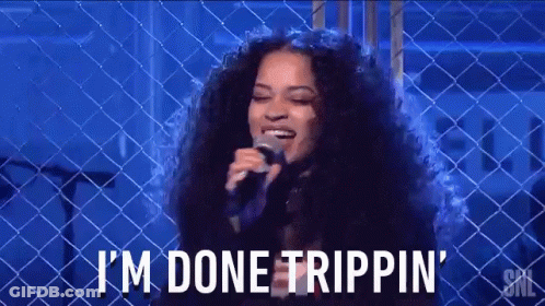A Woman Singing Into A Microphone With The Words I 'M Done Trippin ' On The Bottom GIF