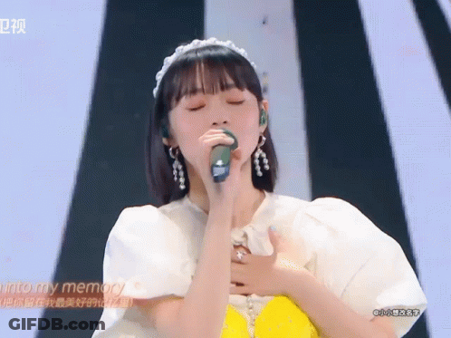 A Woman Singing Into A Microphone With The Words Into My Memory Written On The Bottom GIF
