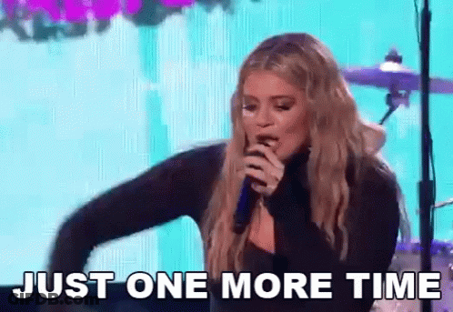 A Woman Singing Into A Microphone With The Words Just One More Time Behind Her GIF
