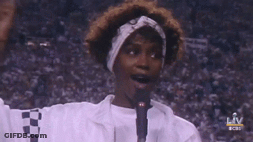 A Woman Singing Into A Microphone With The Words Liv Behind Her GIF
