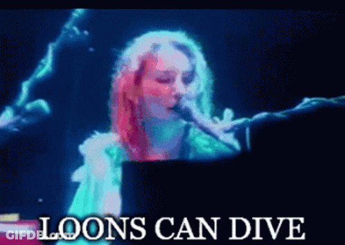 A Woman Singing Into A Microphone With The Words " Loons Can Dive " Above Her GIF