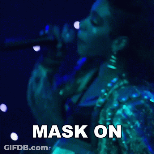 A Woman Singing Into A Microphone With The Words Mask On Written On The Bottom GIF