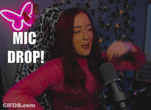 A Woman Singing Into A Microphone With The Words " Mic Drop " Behind Her GIF