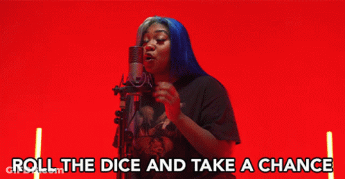A Woman Singing Into A Microphone With The Words " Roll The Dice And Take A Chance " Below Her GIF