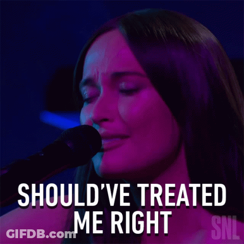 A Woman Singing Into A Microphone With The Words Should Ve Treated Me Right Above Her GIF