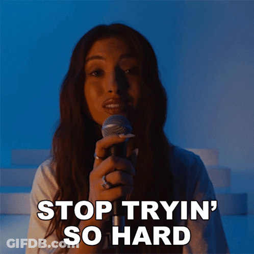 A Woman Singing Into A Microphone With The Words Stop Tryin ' So Hard Written Below Her GIF