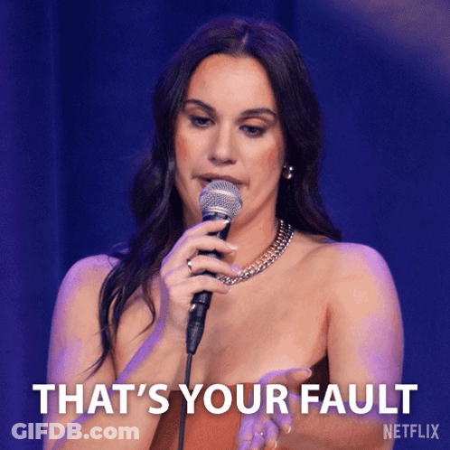 A Woman Singing Into A Microphone With The Words That 'S Your Fault On The Bottom Right GIF