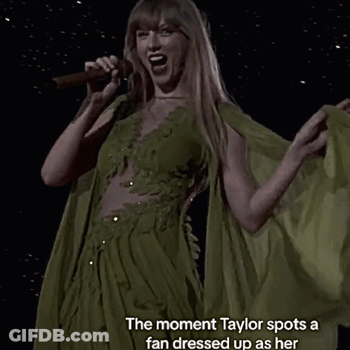 A Woman Singing Into A Microphone With The Words " The Moment Taylor Spots A Fan Dressed Up As Her " GIF