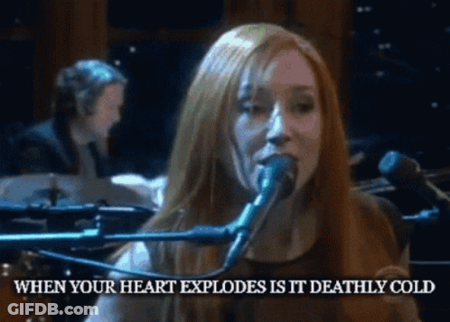 A Woman Singing Into A Microphone With The Words When Your Heart Explodes Is It Deathly Cold GIF