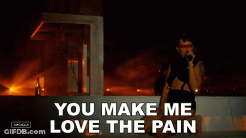 A Woman Singing Into A Microphone With The Words " You Make Me Love The Pain " GIF
