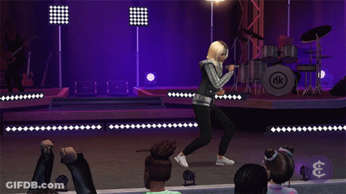 A Woman Singing On Stage In Front Of A Drum Set With Nk On It GIF