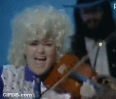A Woman Singing While A Man Plays The Violin GIF