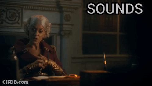 A Woman Sits At A Desk With The Words " Sounds Ridiculous But Go On " Below Her GIF