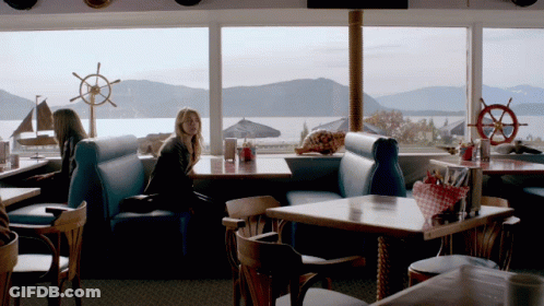 Woman Sitting At Waterfront Restaurant GIF