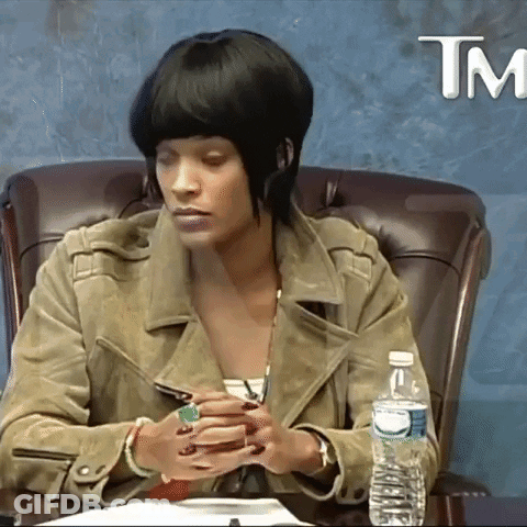 A Woman Sits At A Table With A Bottle Of Water And A Tm Logo GIF