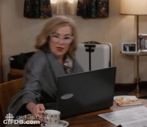 Woman Sitting With Laptop And Coffee Hashtag Schitts Creek GIF