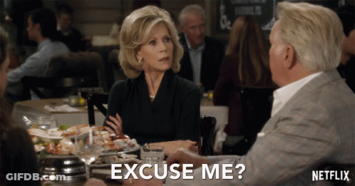 A Woman Sits At A Table With A Man And Says " Excuse Me " In Front Of Her GIF