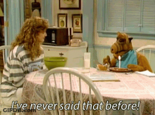 A Woman Sits At A Table With A Stuffed Animal That Says " I 'Ve Never Said That Before " GIF