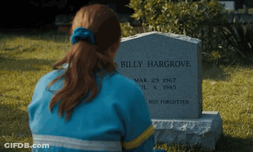 A Woman Sits In Front Of A Gravestone That Says Billy Hargrove GIF