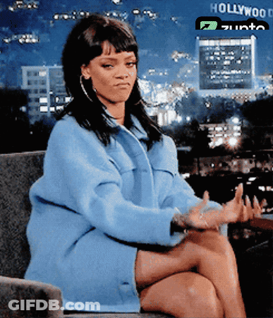 A Woman Sits In Front Of A Hollywood Sign GIF