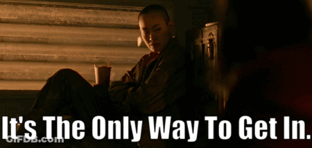 A Woman Sits In Front Of A Window With The Words " It 'S The Only Way To Get In " Above Her GIF