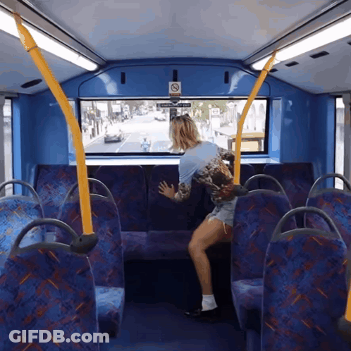 A Woman Sits On A Bus With A Sign That Says No Smoking GIF