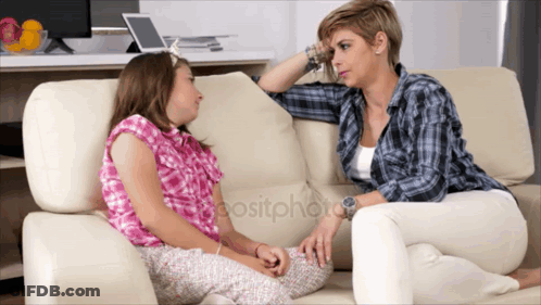 A Woman Sits On A Couch Talking To A Little Girl GIF
