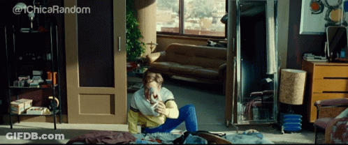 A Woman Sits On The Floor In A Living Room With The Words @ 1Chica Random Written Above Her GIF