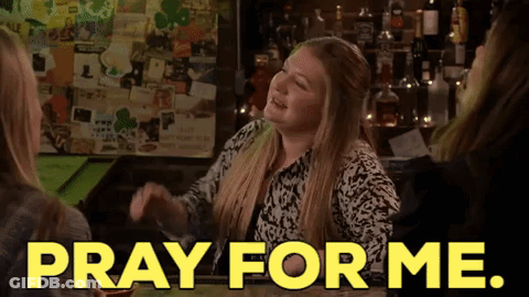 A Woman Sitting At A Bar With The Words Pray For Me On The Screen GIF