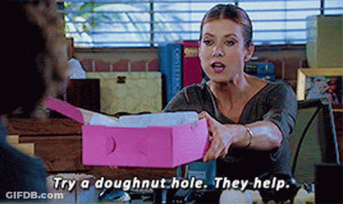 Woman Sitting At Desk Holding Doughnut Hole Box GIF