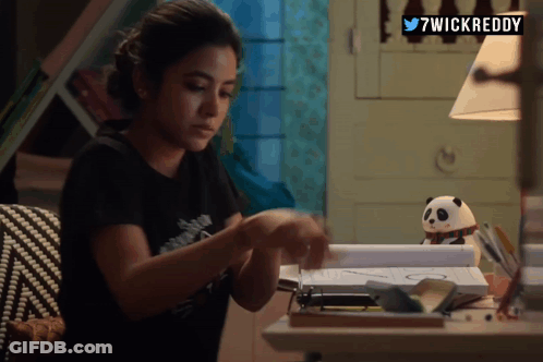 A Woman Sitting At A Desk With 7Wickreddy Written On The Top Right GIF